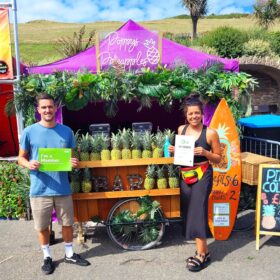 NCASS members Josh and Poppy of Poppy's Pineapples holding their NCASS 'I'm a Member' signs.