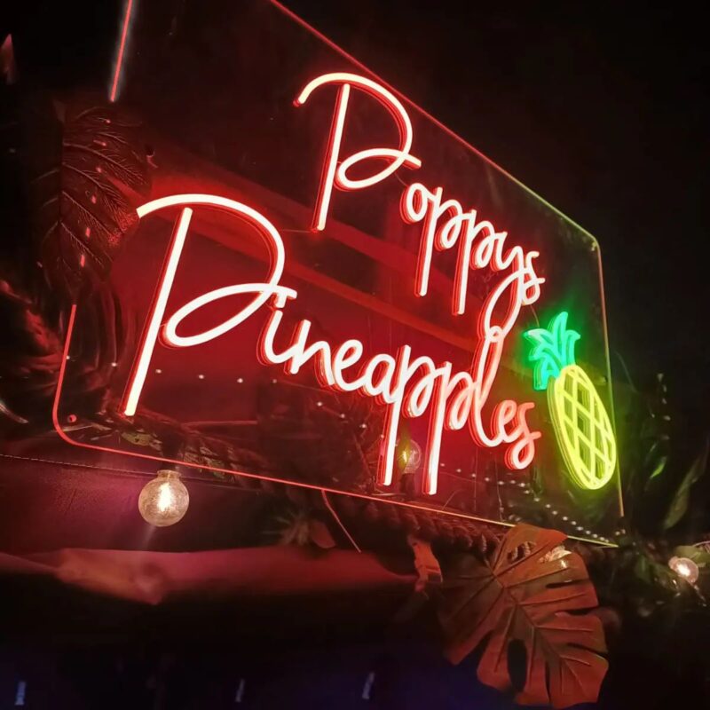 Neon sign of NCASS Member Poppy's Pineapples.